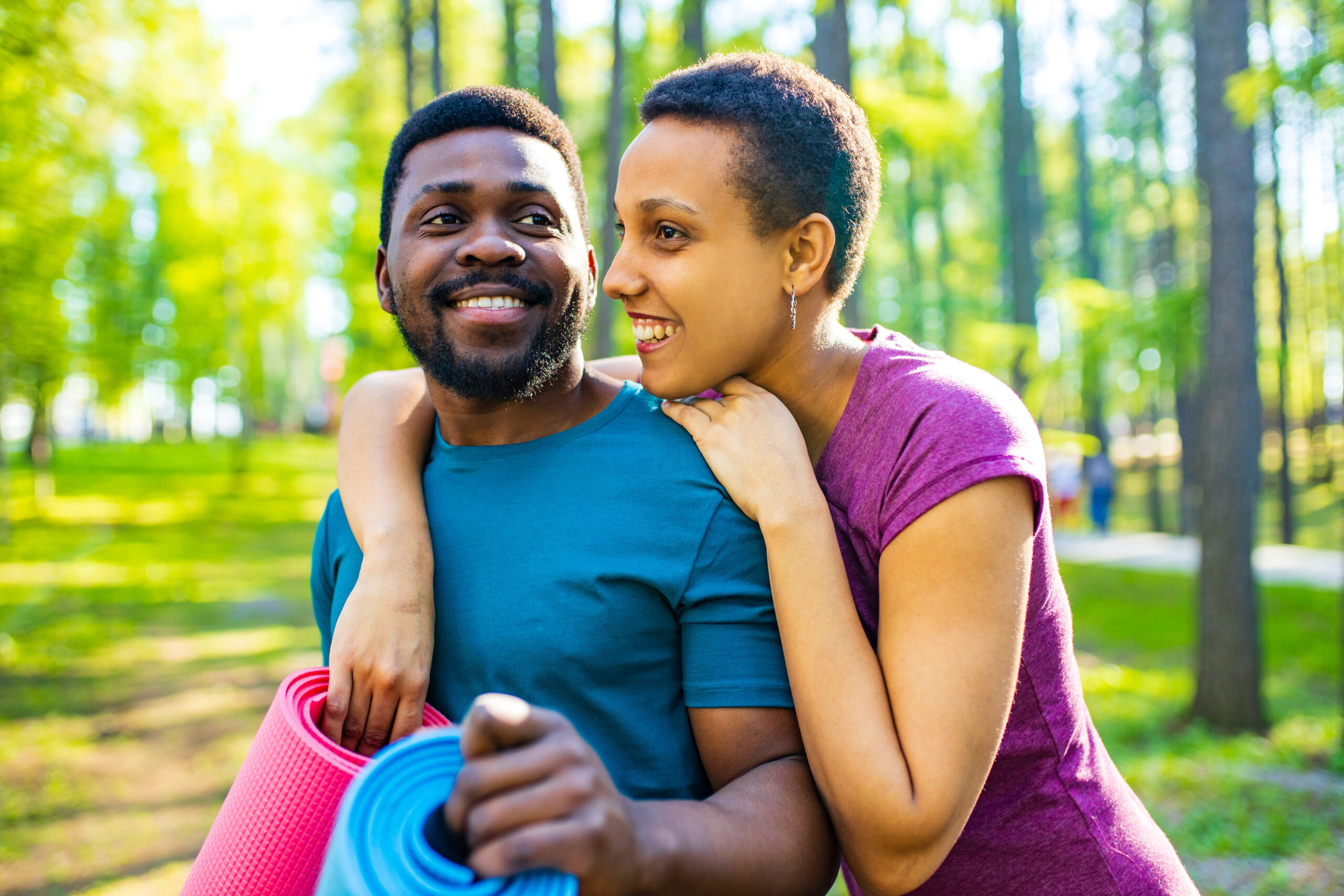 latin american couple ready to yoga time outdoors pink and blue look